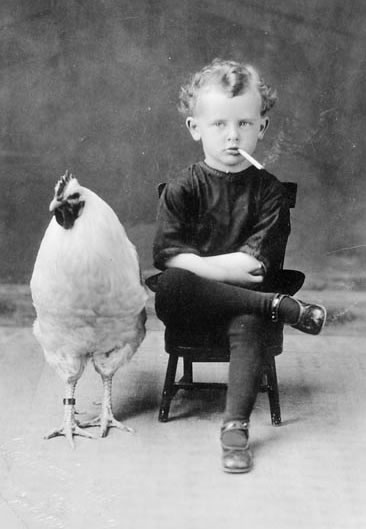 A young child and a chicken — neither of whom should smoke.
