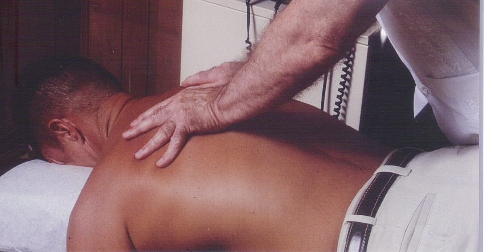 A chiropractor doing spinal manipulation.