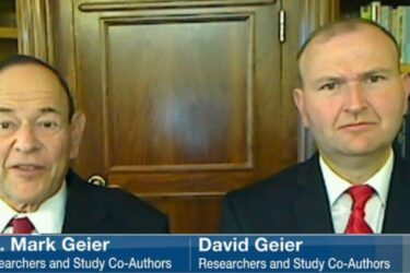 Two men in suits, identified as Dr. Mark Geier and David Geier, appear on a Fox 19 news broadcast. Both are seated indoors in front of a wooden cabinet and bookshelves, with name labels shown at the bottom.