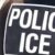 A close-up of the back of a person wearing a vest labeled "POLICE ICE," indicating they are part of the U.S. Immigration and Customs Enforcement agency. The background is blurred.