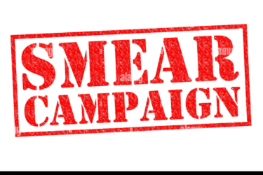 Red, distressed stamp-style text on a white background reads "SMEAR CAMPAIGN" in all capital letters.