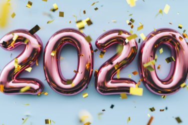 Shiny pink balloon numbers forming "2020" with gold confetti falling in front of a light blue background, creating a festive atmosphere.