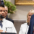 A doctor in a white coat speaks at a podium next to a man in a suit and striped tie, with others standing in the background.
