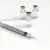 A syringe with a needle is placed in front of three small glass vials containing a clear liquid, all set on a white surface.