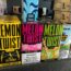 Colorful boxes of Lemon Twist and Melon Twist e-liquid are displayed on a store shelf. Warning labels and flavors are visible. Other vape products are partially visible on either side.