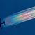 A commercial airplane in flight, leaving a bright, iridescent rainbow-colored contrail against a deep blue sky.